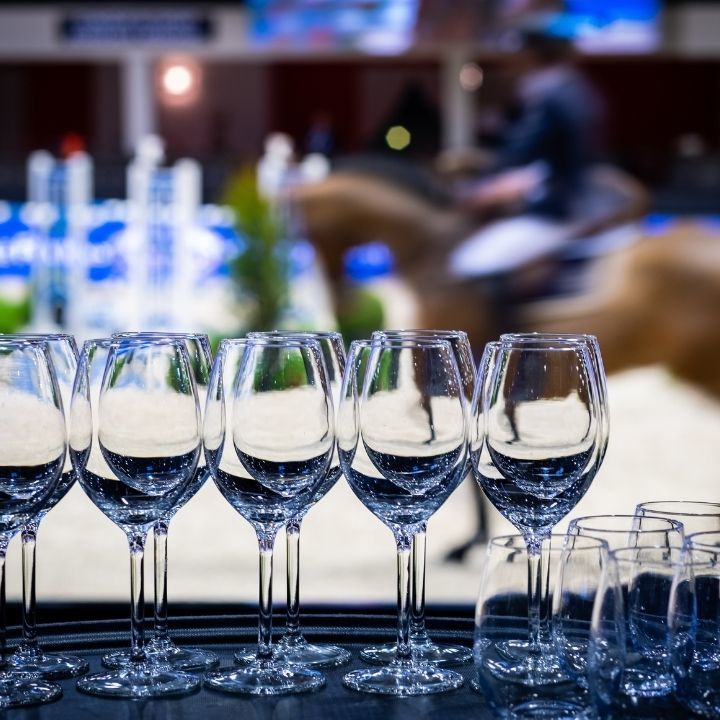 Verres à pied sur table noir avec un cheval derrière